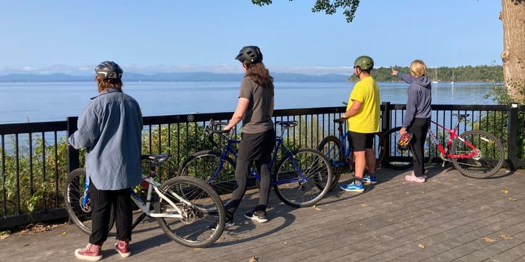 A group of Rock Point School students stand at the Burlington waterfront with their bikes after biking from campus to look at the views across the Lake Champlain.